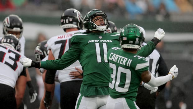 Jets' defender Jermaine Johnson and Michael Carter II